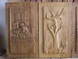 Carved panels made of chestnut wood, bas-reliefs 'Ninna nanna contadina' (Peasant lullaby) and 'Rinascere' (Revice)