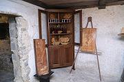 Corner cupboard in walnut with exhibition of sculptures: on the left 'Illusione della liberta' (Illusion of freedom) in mulberry wood and on the right 'Tralcio d'uva' (Grape shoot) in chestnut wood